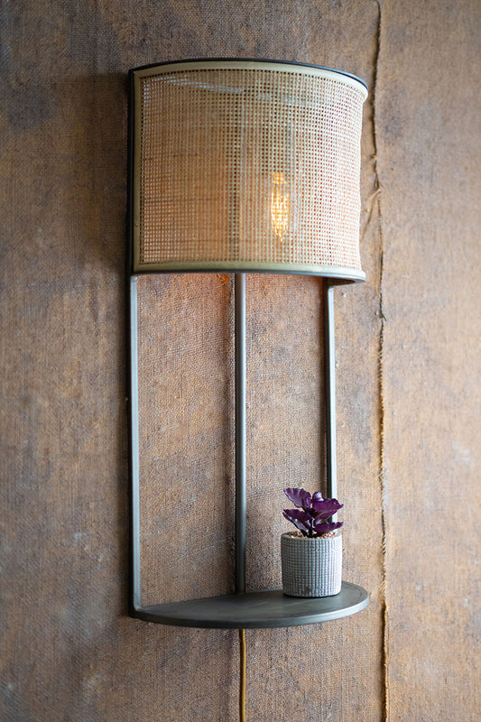 Wall sconce light with rattan shade and metal shelf